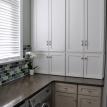 Laundry Room featuring glass tile backsplash