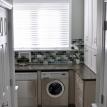 Laundry Room featuring glass tile backsplash