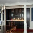 Wet bar, dark stained cabinets, marble counters, leaded glass doors